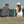 Couple assis sur un quai bord de lac avec casquettes bleu et blanche fabriqués par Volprivé 100% coton / Couple sitting on a dock of a bay near lake wearing blue and white cap made in Canada by Volprivé.