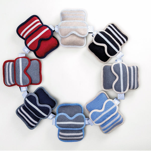 Assortiment d'oreillers de voyage et masques assortis en laine de mérinos / Assortment of travel pillows and assorted sleep masks made in Canada by Volprivé.