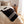 Jeté noir avec rayures blanches en laine de mérinos sur lit / Black with white stripes merino wool throw on bed made in Canada by Volprivé.