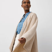 Jeune femme portant châle en laine mérinos beige / Young women wearing a beige merino wool shawl made in Canada by Volprivé.